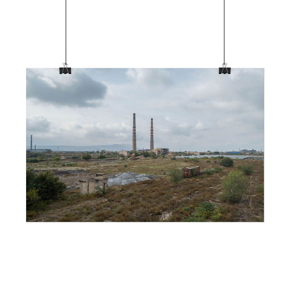 Thumbnail: Abandoned industrial landscape with tall smokestacks under a cloudy sky.