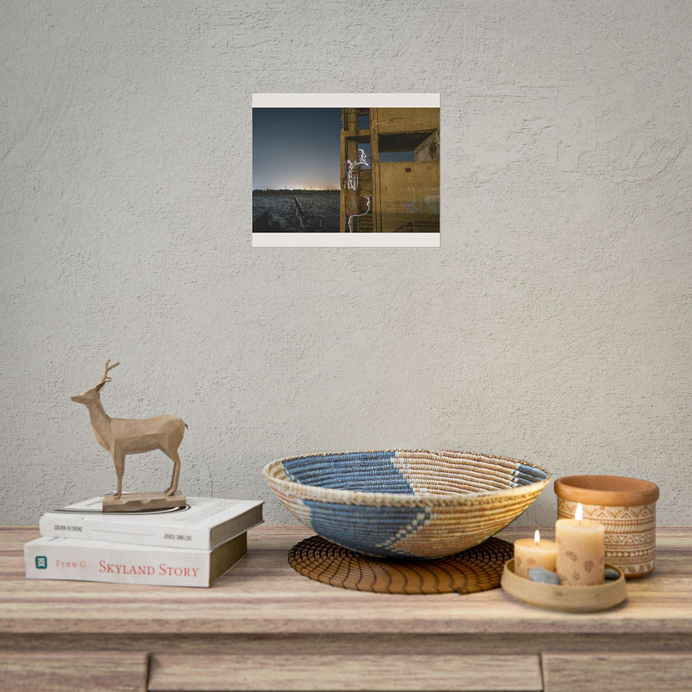 Thumbnail: Framed poster of geometric building, dark sky, above table decor.