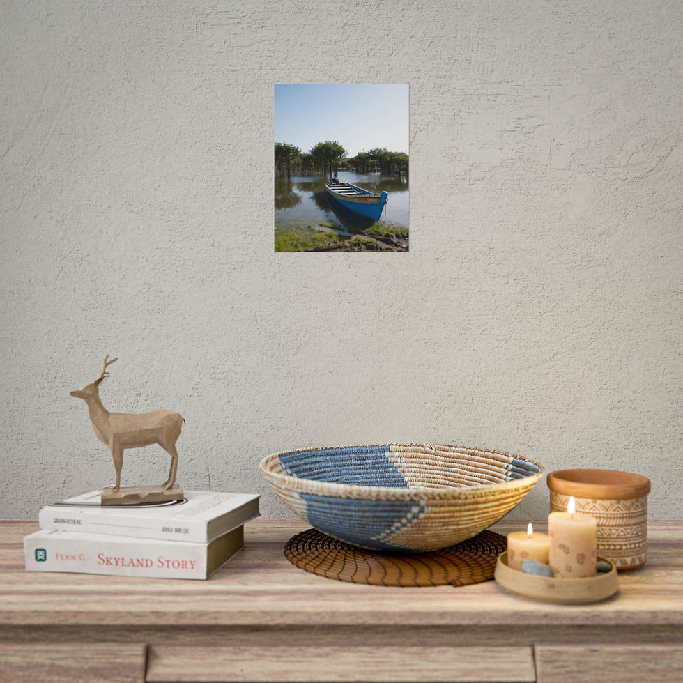 Thumbnail: Cozy room decor with framed picture of blue boat on tranquil water.