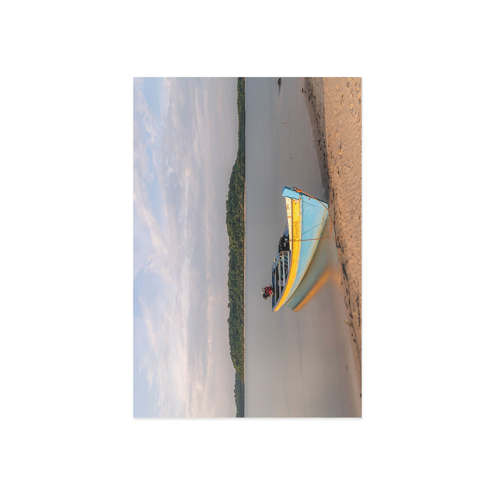 Thumbnail: Colorful yellow and blue boat floating near sandy shore under cloudy sky.