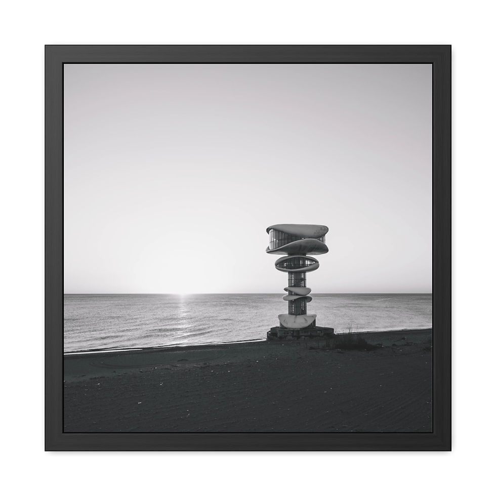 Thumbnail: Black and white framed print of a sculpture by the sea at sunrise.
