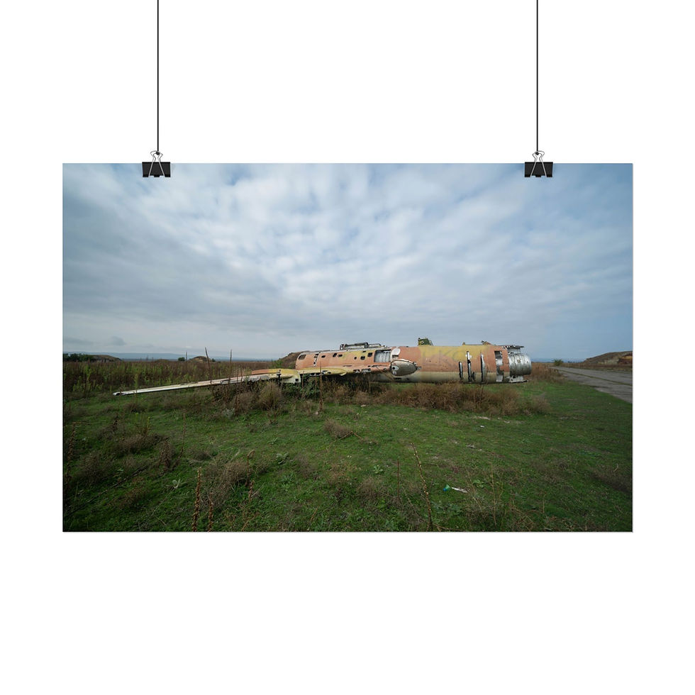 Thumbnail: Wrecked airplane fuselage lying on grassy ground under a cloudy sky.