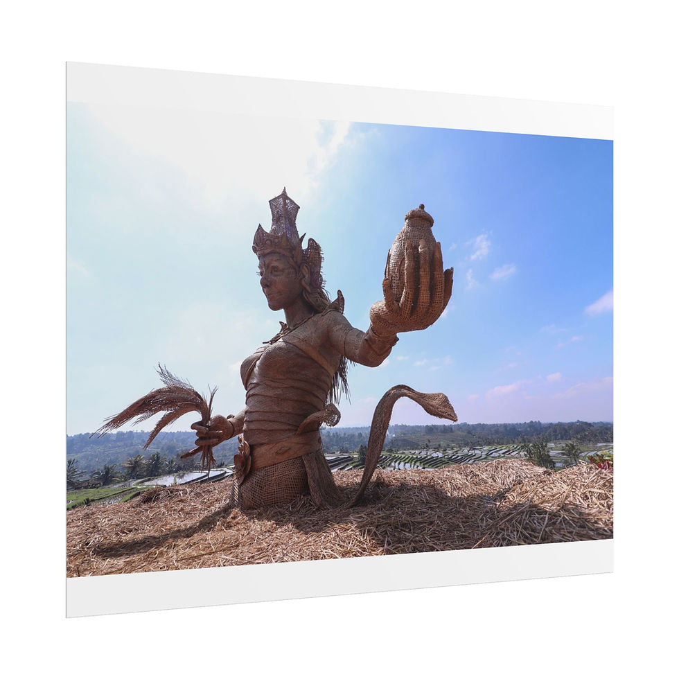 Thumbnail: Intricate sculpture of goddess holding sacred offering against bright blue sky.