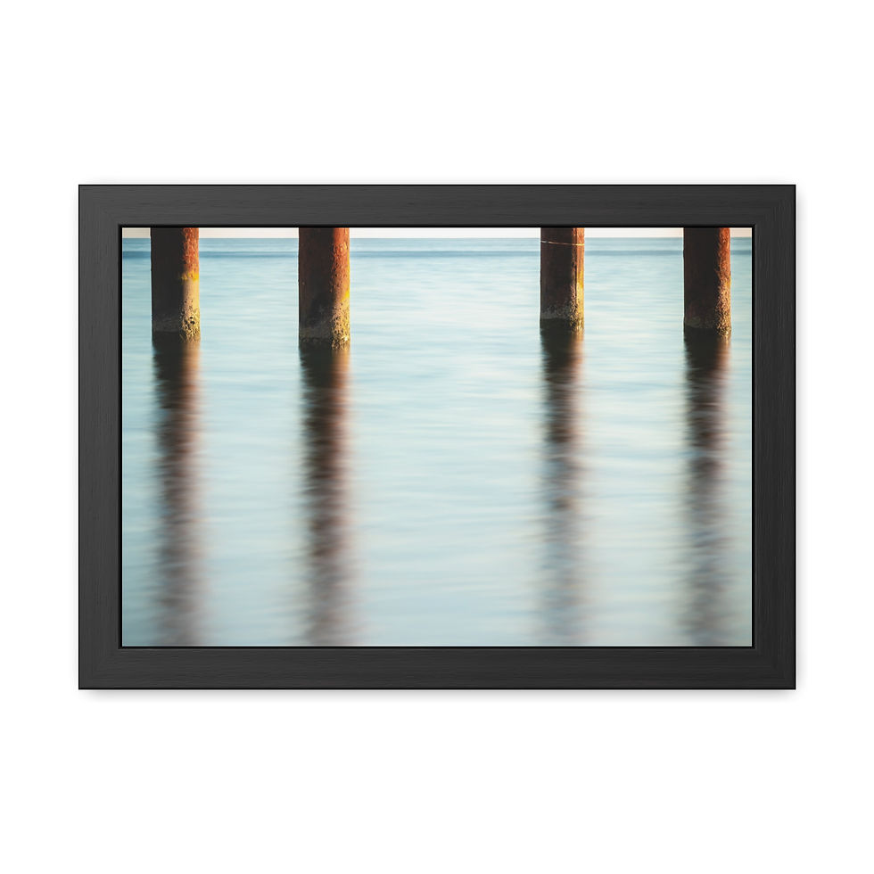 Thumbnail: Four dark pillars reflected in calm blue water, framed art.