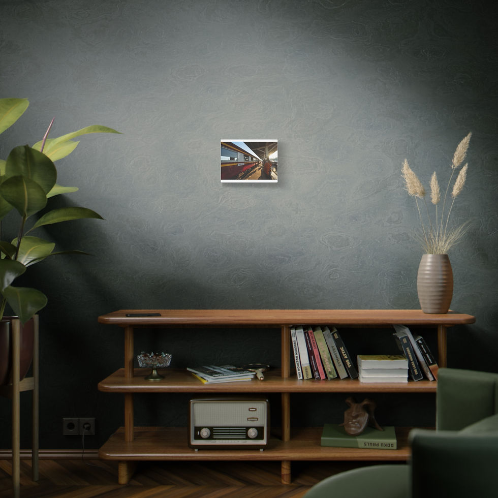 Thumbnail: Small framed picture on dark wall above wooden console with books.