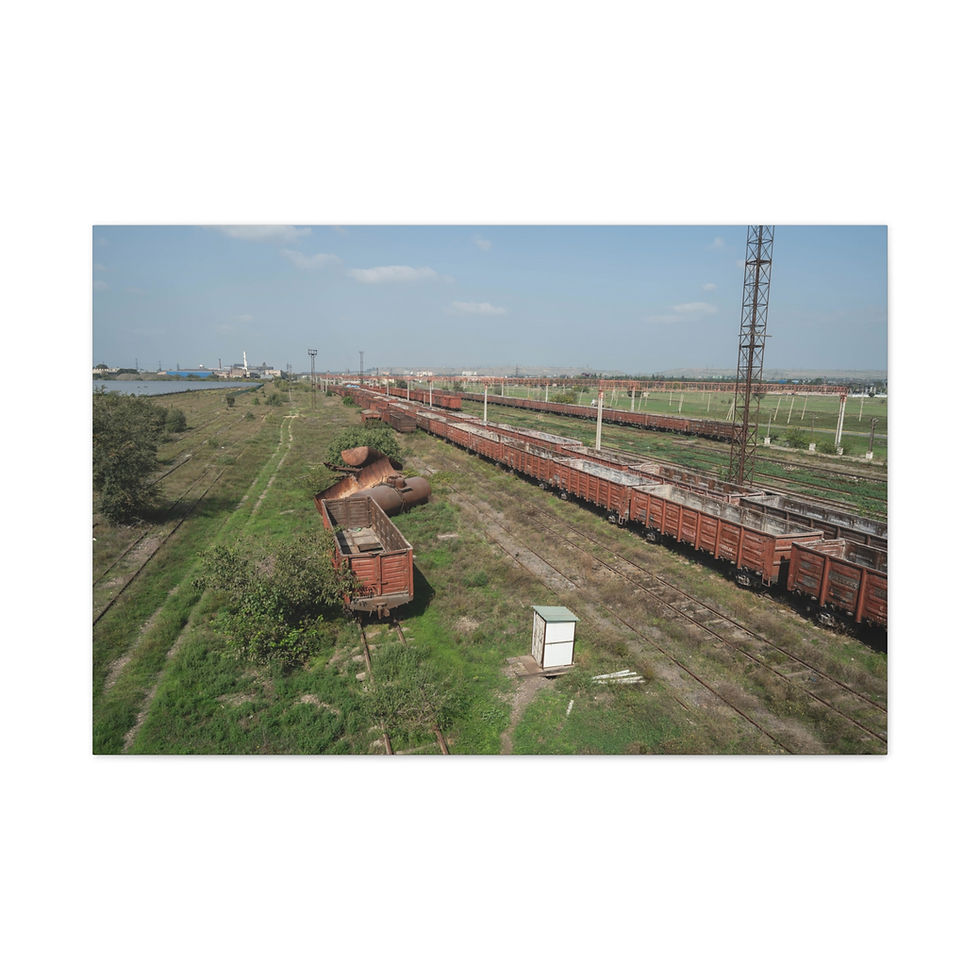 Thumbnail: Long freight train on tracks through a green industrial landscape.
