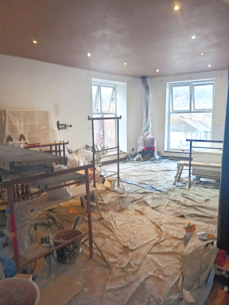 Plastering scaffolding in large living room renovation