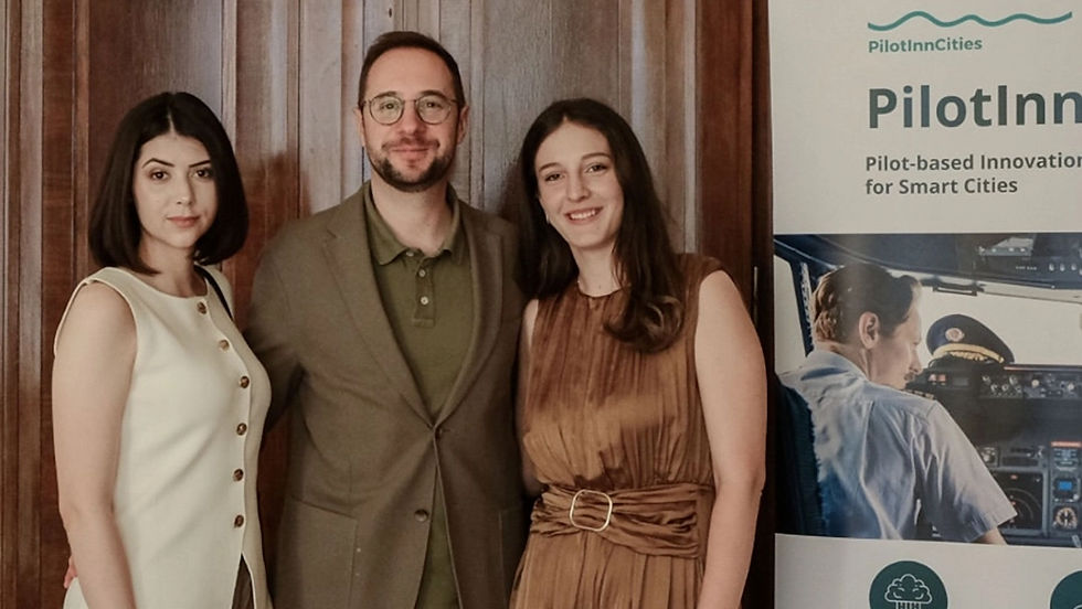 ParkLife team members at the PilotInn Cities event, standing next to a promotional banner for the smart cities program supported by Digital Serbia Initiative.