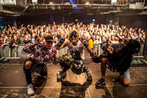 Ian Erix poses on stage with his dancers following concert in London, UK