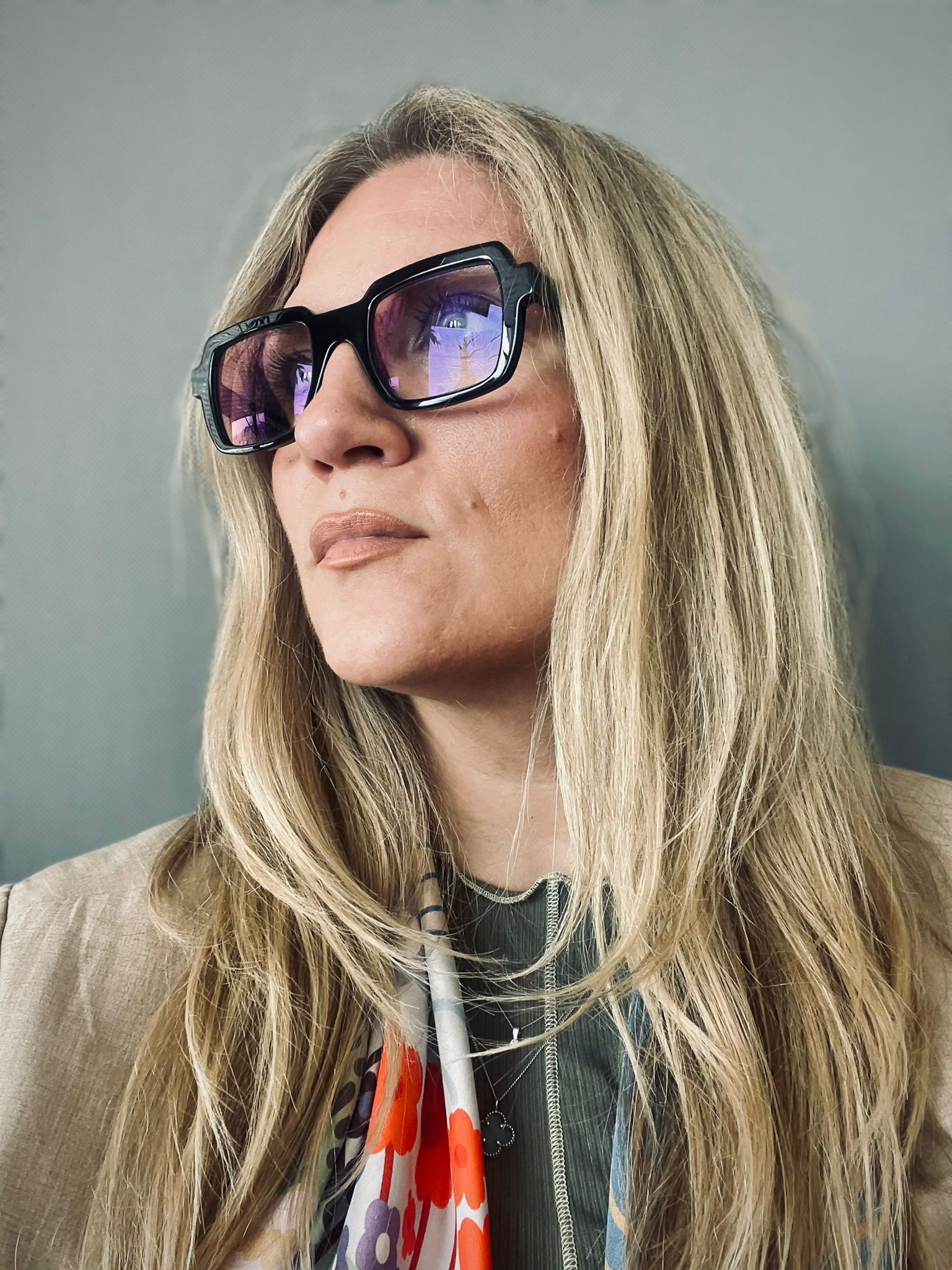 A happy customer smiling after a rejuvenating skin treatment, showing clear and radiant skin in a relaxing spa environment.