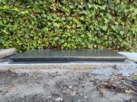 Trampilla de aluminio anodizado en un pasillo interior.