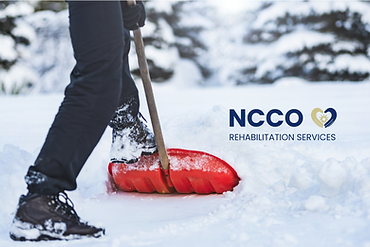 Person pushing a red shovel in the snow
