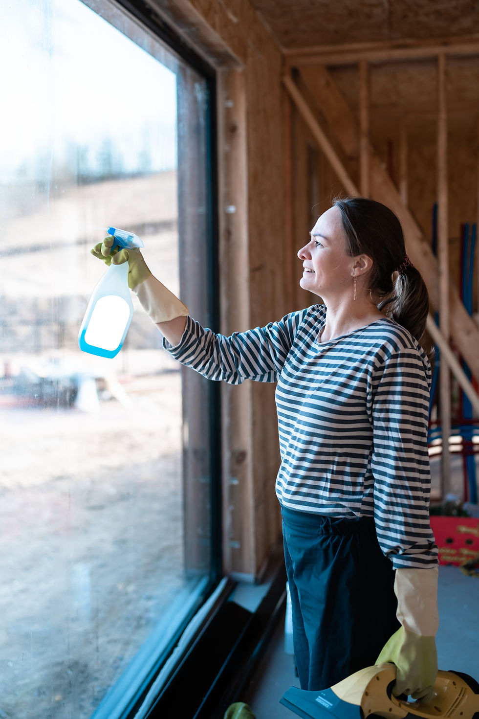 smiling-woman-wearing-protective-gloves-spraying-c-2025-01-09-02-09-11-utc.jpg