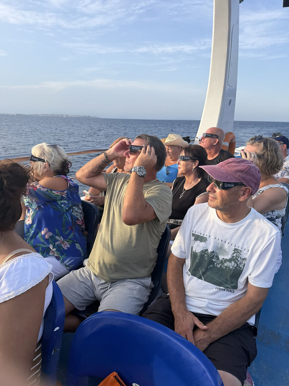 Guests on the Torrevieja cruise use certified solar eclipse glasses during the partial phase.