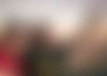 Two people wearing eclipse glasses, looking amazed.