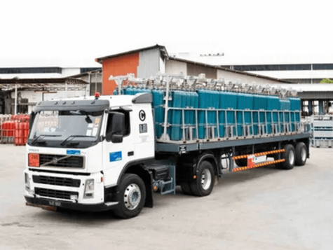 Industrial gas cylinders being delivered safely to a facility in Malaysia by a professional gas delivery service.