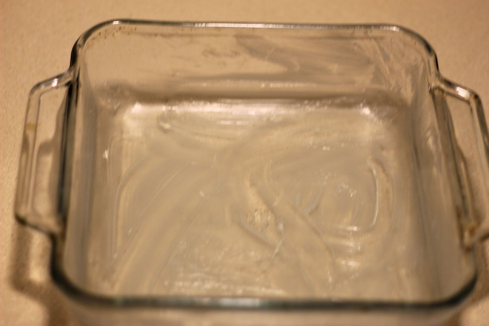 An 8 x 8 pan with butter in it.