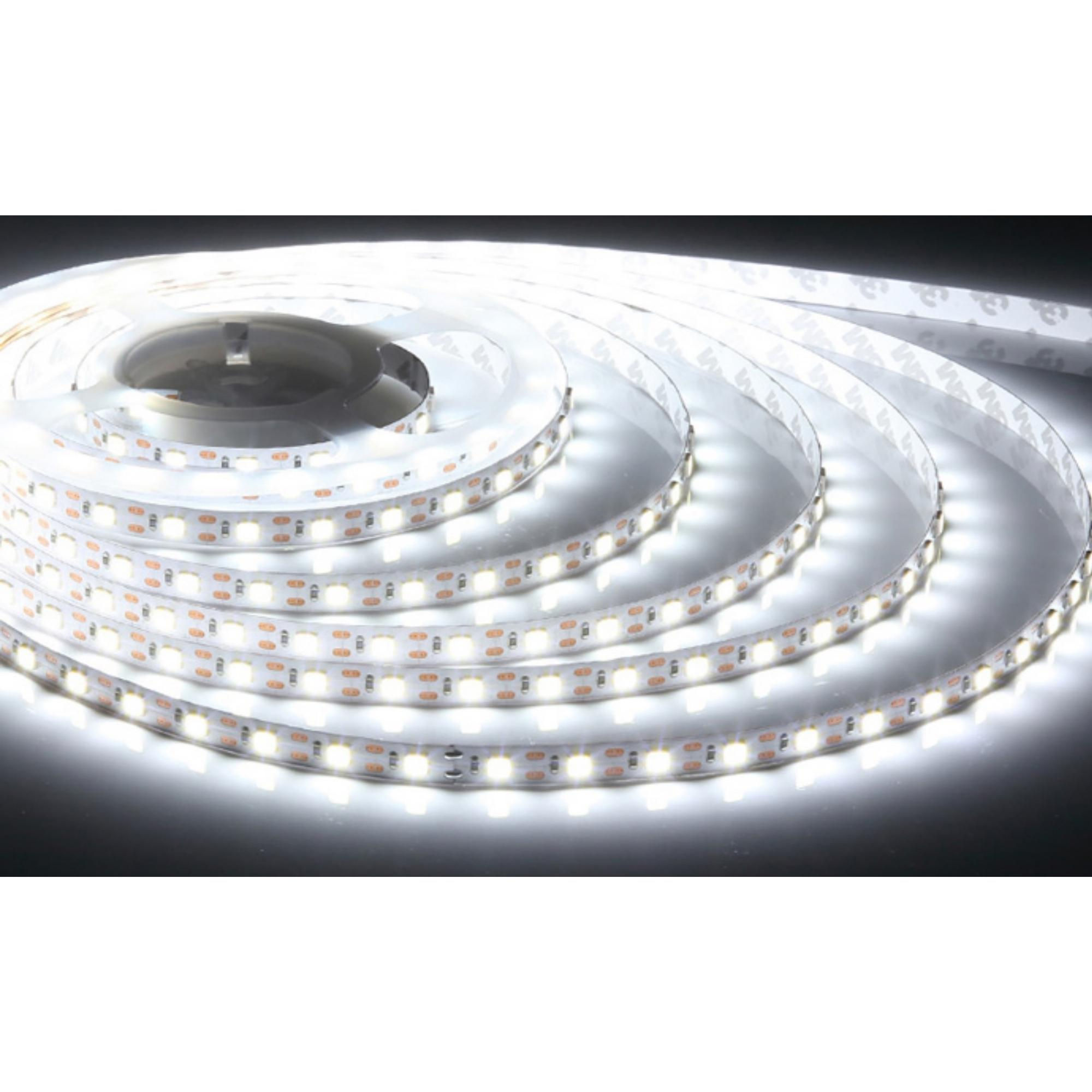 Coiled cool white LED light strip glowing on dark surface