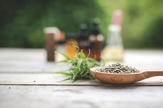 cannabis-cannabis-seeds-cannabis-oil-placed-wooden-floor-with-green-tree-background.jpg