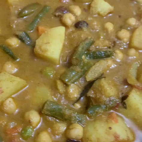 Mix vegetables in roasted coconut curry with chickpeas and kidney beans