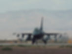 F-16 fighter jet on runway, 'Esaias Ruiz Photography' watermark, mountains background.