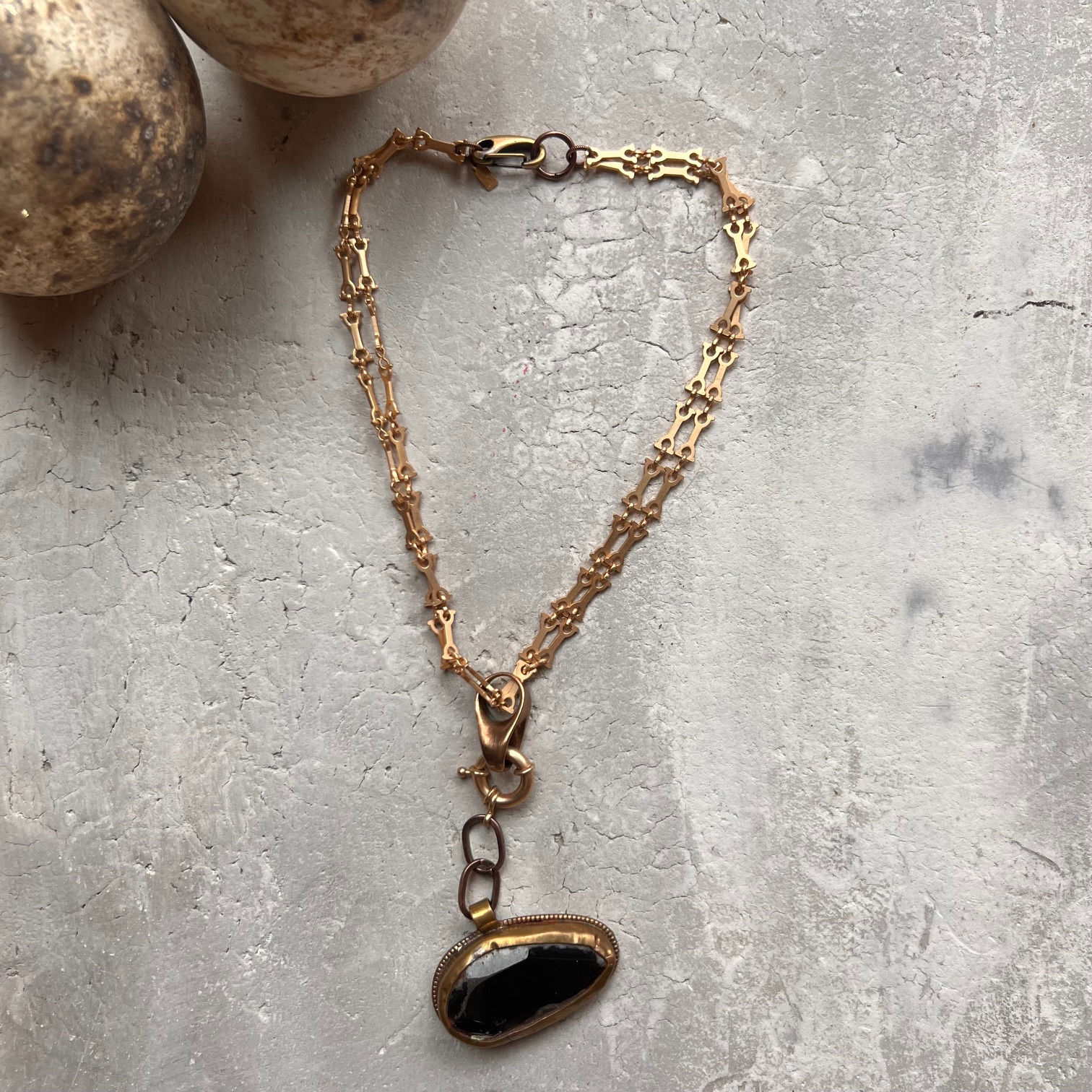 Purplish brown pendant on matte gold