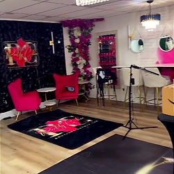 Actual Pretty Chic studio: hot-pink lounge chairs and white bar stools