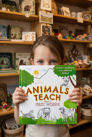 Animals Teach First Words Volume 2 - Young child buying the book at a local gift shop