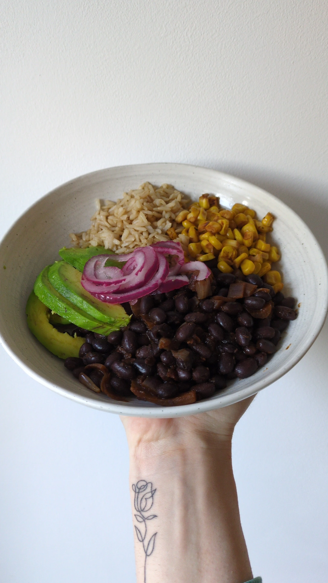High-fibre black bean and brown rice bowl with avocado and vegetables for gut health.