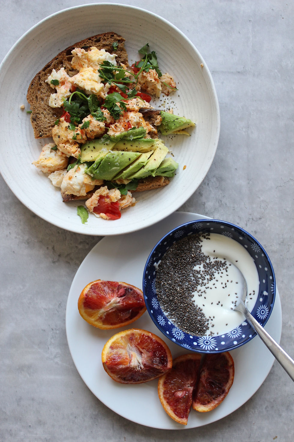 A hormone-supportive breakfast of scrambled eggs on seed-sprouted sourdough with a chia seed yoghurt and blood orange illustrating practical zinc-rich meal building from Balanced Imogen's food-first approach to women's hormone health.