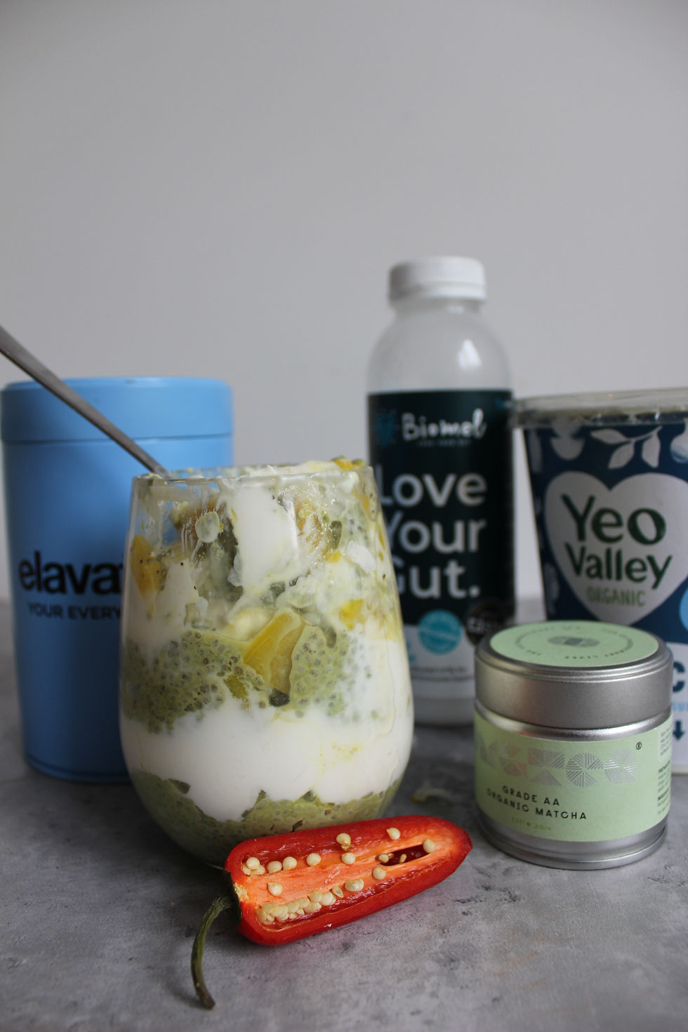 Hormone-supportive ingredient flat lay for Balanced Imogen's pineapple chia pudding- featuring Elavate collagen, Biomel coconut kefir, Yeo Valley Greek yoghurt and Grade AA organic matcha, a cycle-synced recipe for the follicular and ovulatory phases on The Balanced Edit.