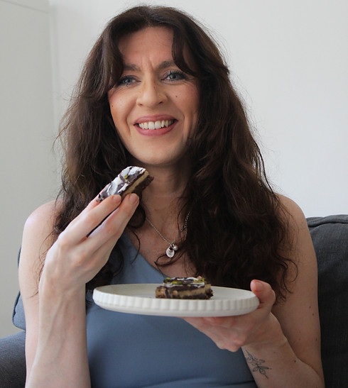 Imogen Honour enjoying a nourishing snack, founder of Balanced Imogen
