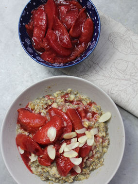Stewed plum compote served over chia seed porridge and flaked almonds for balanced blood sugar support