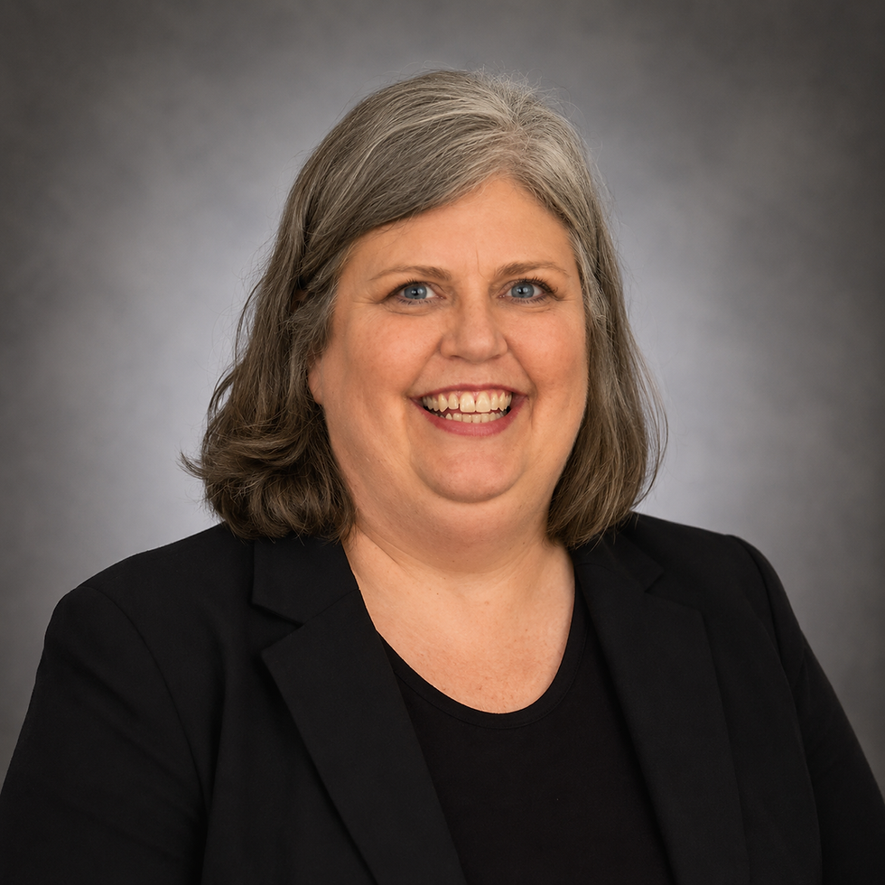 Smiling woman with gray hair wearing a black blazer.