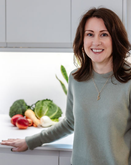 Lisa Claire, Gut Health Nutritionist, standing in her kitchen