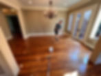 Elite Floor Care team performing a screen and recoat on pine hardwood floors during a sand-free refinishing project.