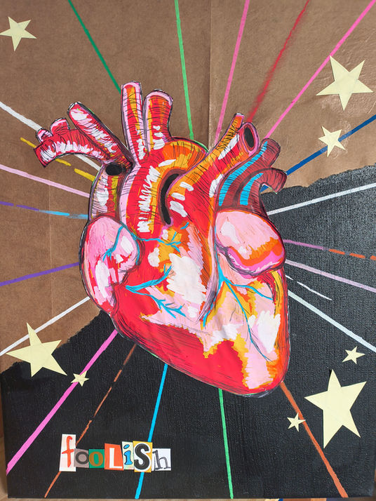 An anatomical heart in the middle of a starburst, surrounded by smaller paper stars. The lettering reads "foolish".