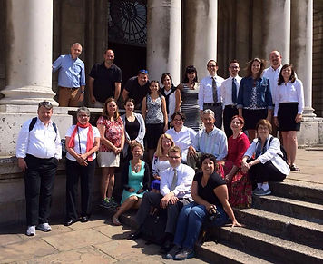 Choir posing on stone steps in front of old church