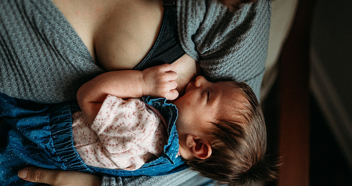 Nursing newborn baby