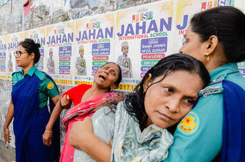 Relatives of the deceased mourn after a girder accidentally fell from a crane on a passing-by car in Dhaka, Bangladesh on August 15, 2022.