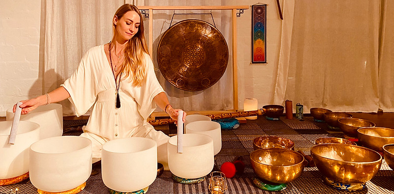 Viktoria from Seed of Life Healing playing crystal singing bowls at her New Moon event in Bondi Beach.