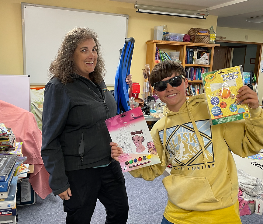 Congregation members holding items donated for our annual rummage sale.
