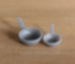 Thumbnail: A pair of 3d printed grey feed scoops.