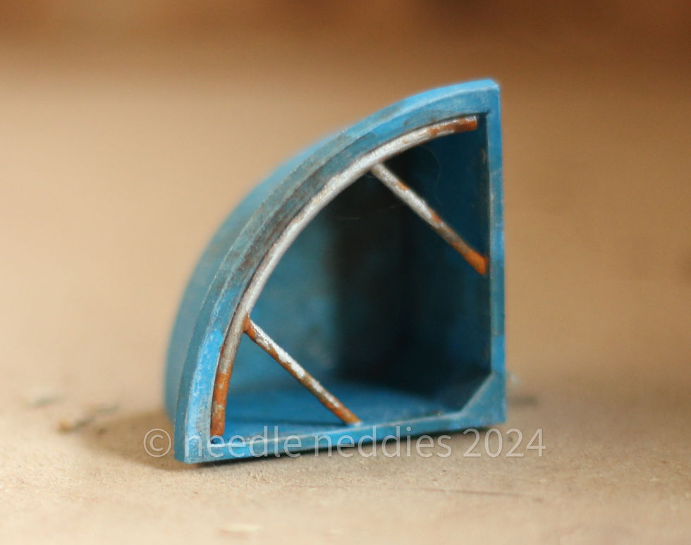 Thumbnail: A weathered light blue corner feeder, on its side showing the inside.
