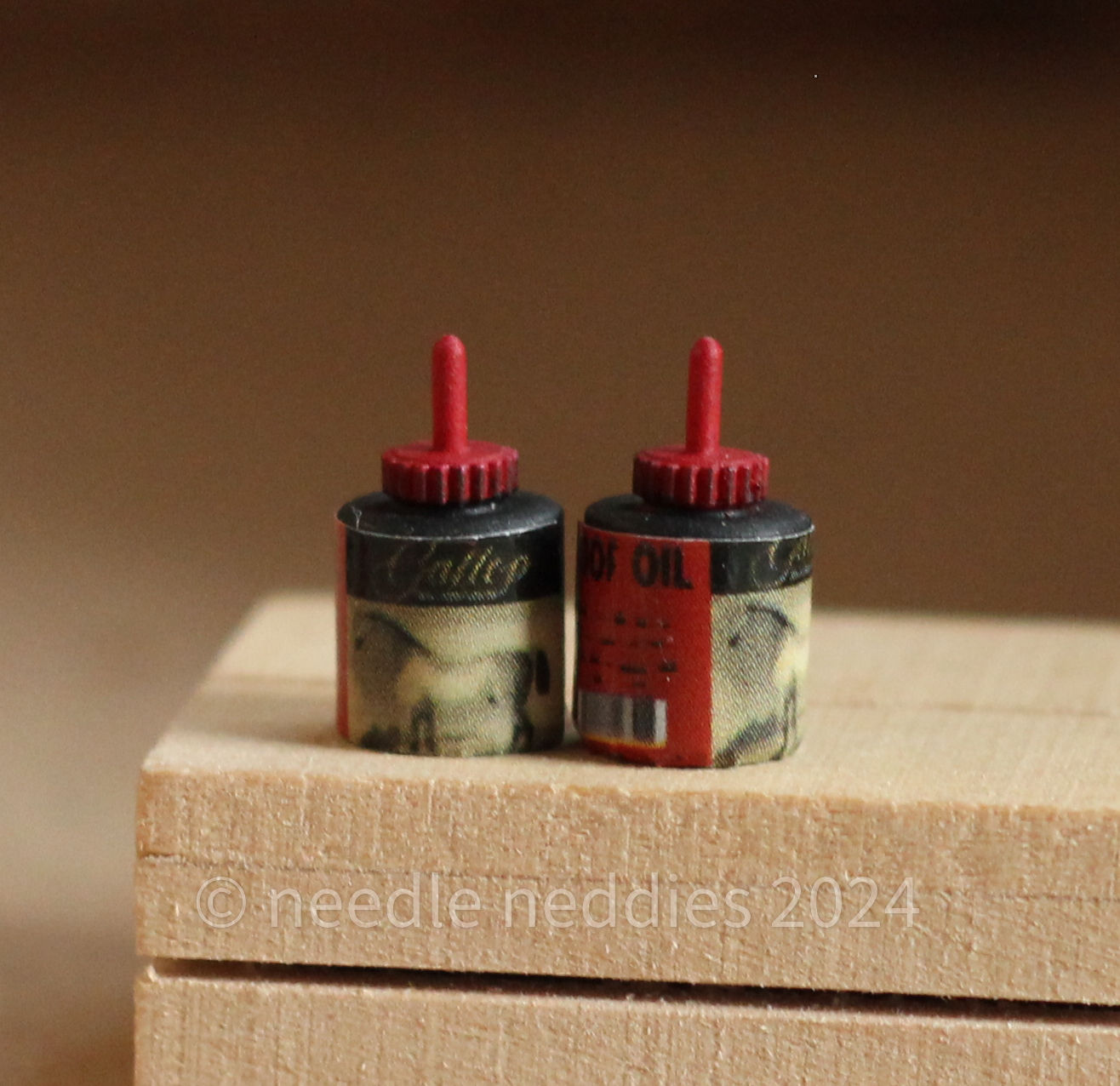 A pair of hoof tar bottles. They are black with red tops, and have a label with a vintage illustration of a horse.