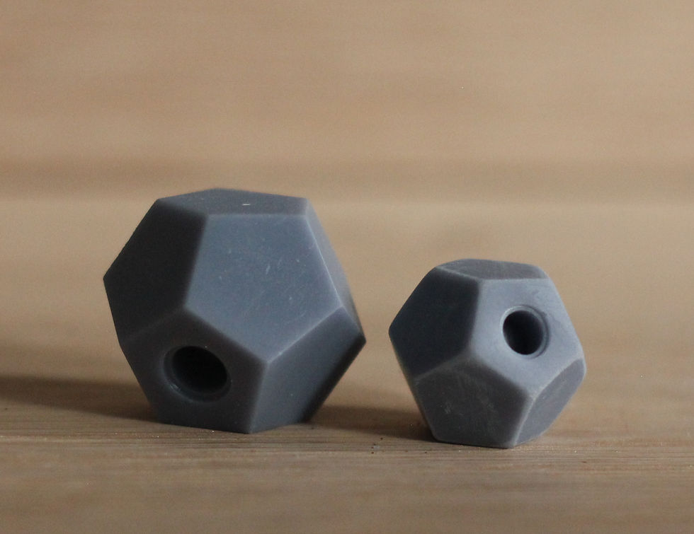 Thumbnail: A pair of 3d printed grey treat balls.