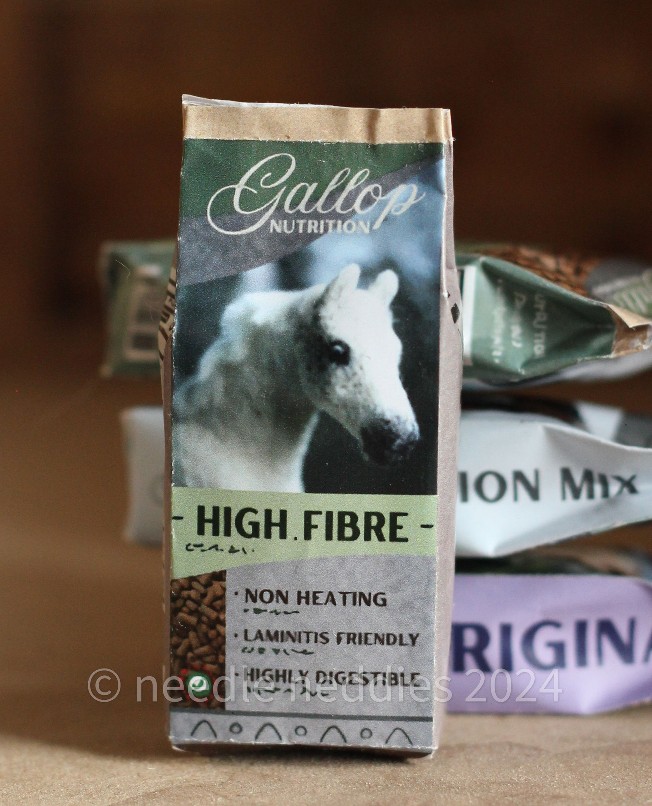 A feed bag. It is made of paper with the picture of a horse in the front.