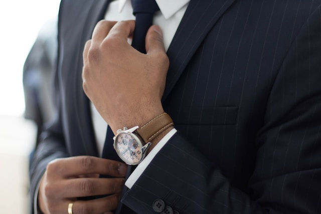 A shot of man with a coat and watch.