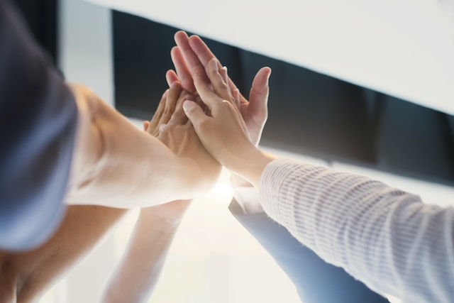 Business team put hands together