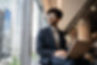 Businessman contemplating in the office looking through the window.